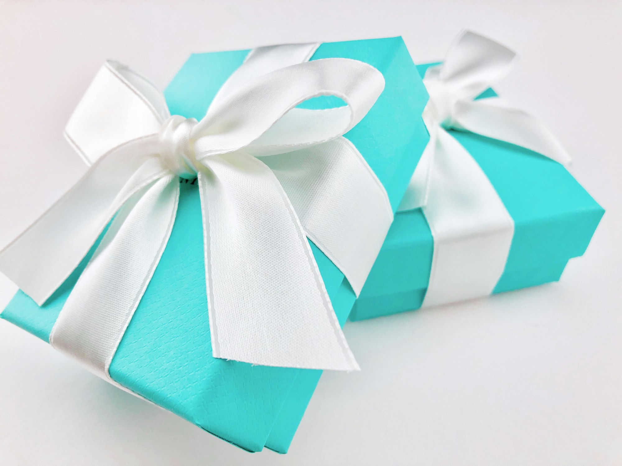 Close up of gifts wrapped in iconic blue boxes with white satin ribbons.